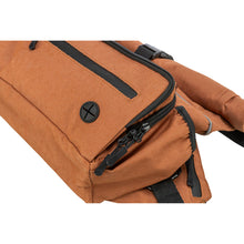 Load image into Gallery viewer, Close-up of a brown fabric bag with black zippers, zipper pulls, and a black circular button detail, shown on a plain white background.