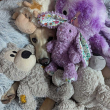 Load image into Gallery viewer, Dog surrounded by stuffed animals on a giant donut dog bed
