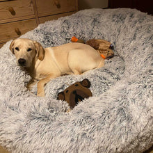 Load image into Gallery viewer, Dog lying on a fluffy gray giant donut bed with toys