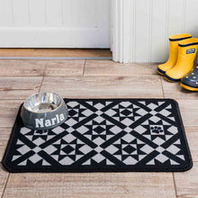 Load image into Gallery viewer, Patterned mat with a pet bowl labeled 'Narla' on a wooden floor, with yellow boots in the background.