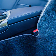 Load image into Gallery viewer, Close-up of a car seat with blue interior and armrest.