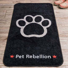 Load image into Gallery viewer, Black mat with a white paw print and 'Pet Rebellion' text on a wooden floor.