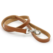 Load image into Gallery viewer, A tan leather dog leash with silver metal hardware, shown coiled on a white background.