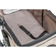 Load image into Gallery viewer, Close-up of a pet stroller interior with a beige fabric seat pad, black trim, and a black adjustable strap with a silver metal clip.
