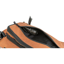 Load image into Gallery viewer, Close-up of a brown bag with black zippers and a black interior, showing an open compartment holding poop bags

