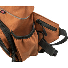 Load image into Gallery viewer, Close-up of a brown canvas bag with black zippers, a black strap, and a small red and white TUEE logo tab on the upper left.
