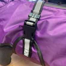 Load image into Gallery viewer, Close-up of a purple waterproof dog coat with a black plastic buckle and gray reflective strap, shown on a dog's body.
