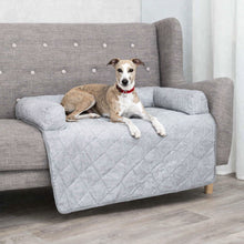 Load image into Gallery viewer, Dog sitting on a gray sofa with a quilted cover in a room.
