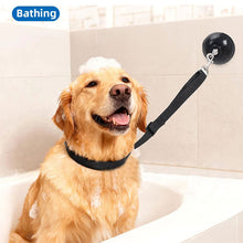 Load image into Gallery viewer, Dog in a bathtub with a shower attachment labeled 'Bathing'.
