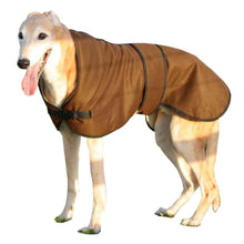 Load image into Gallery viewer, Ted the greyhound wearing our brown coloured wax lurcher coat in the countryside
